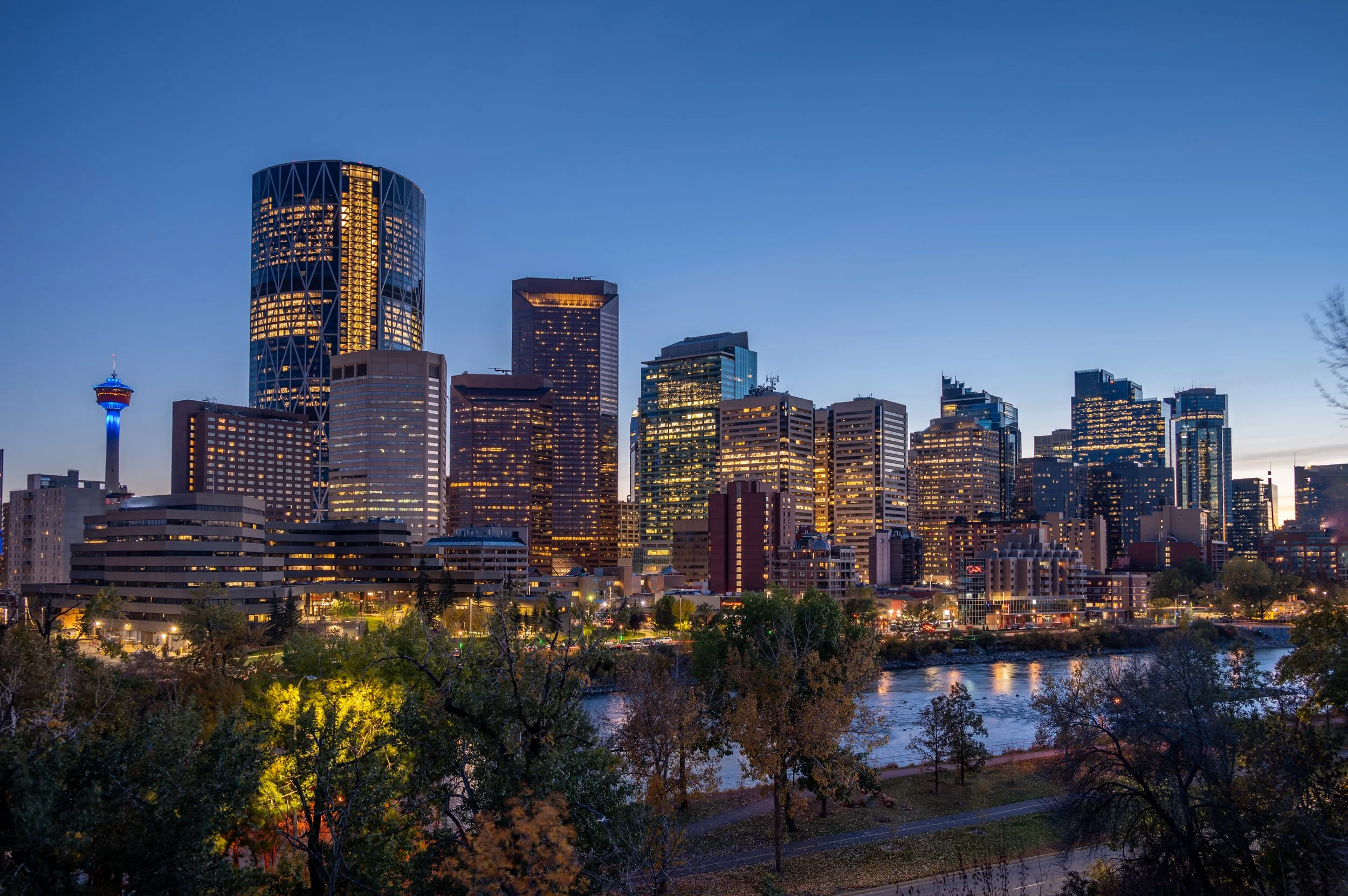 Downtown Calgary skyline at dusk along the Bow River