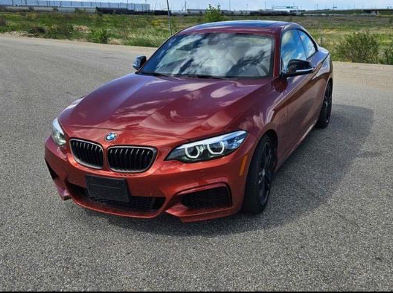BMW M240i xDrive Coupe 2024 in Melbourne Red metallic, front three-quarter view
